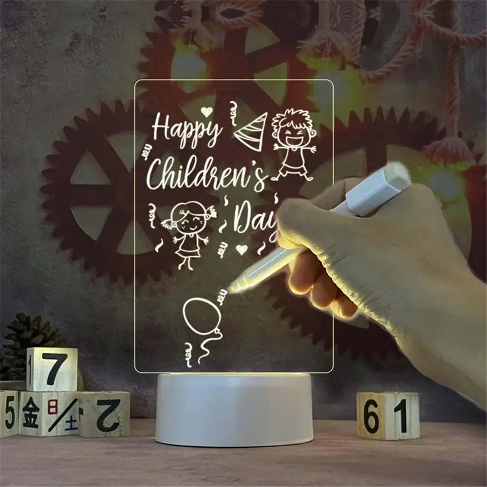 Display de acrílico iluminado com a mensagem ’Happy Children’s Day’ (Feliz Dia das Crianças) e rabiscos, em uma base iluminada.