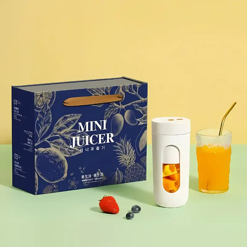 Mini juicer com a caixa de embalagem do produto e um copo de suco de laranja.