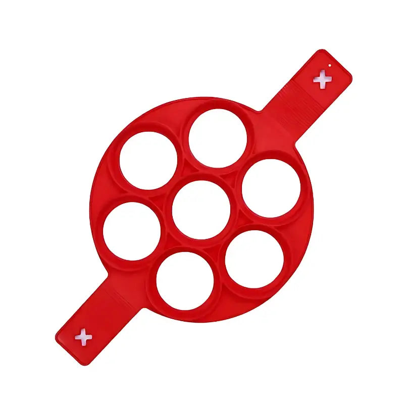 Molde de silicone circular vermelho com sete cavidades redondas e duas alças.