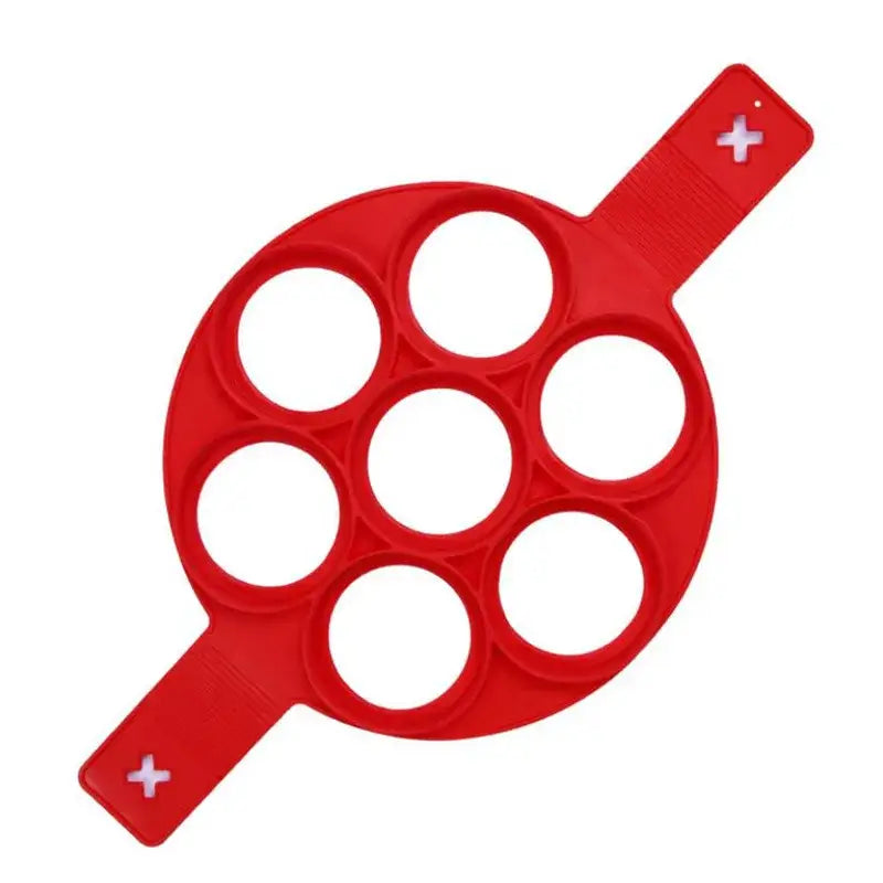 Forma de panqueca de silicone vermelha com sete aberturas circulares.