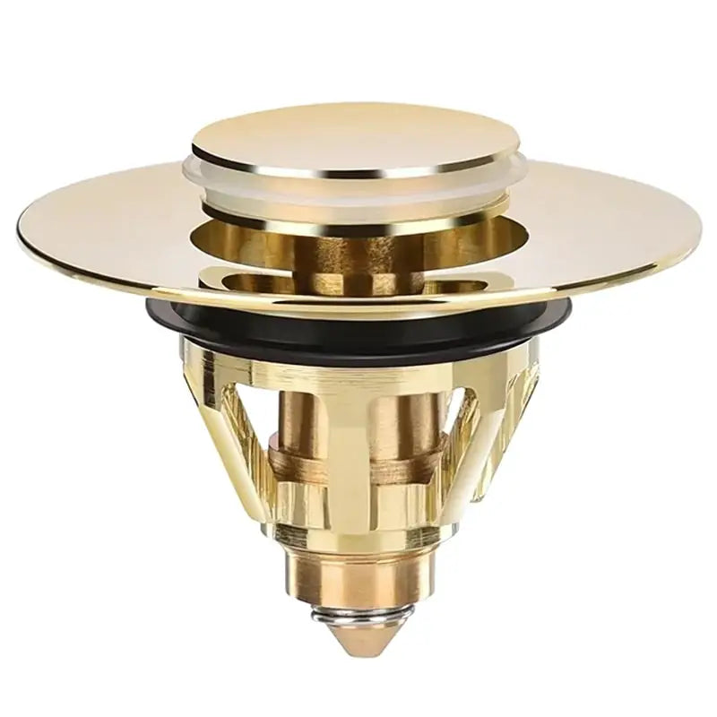 Dreno de metal dourado ou acessório de encanamento com uma parte superior circular e componentes internos complexos.