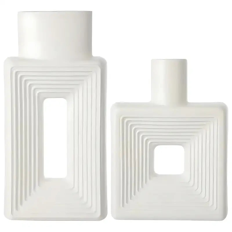 Dois vasos de cerâmica branca com desenhos geométricos em degraus em seus corpos.